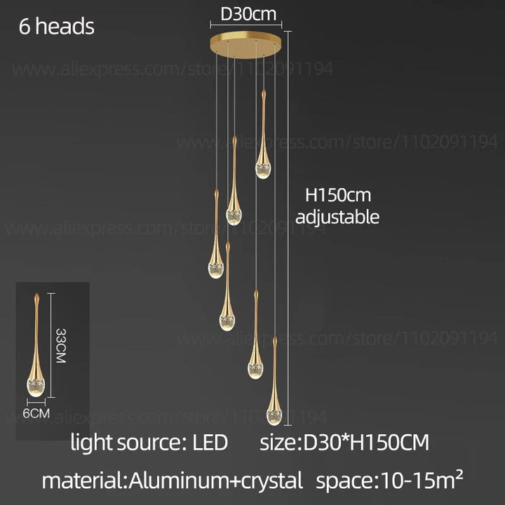 Moderna lámpara colgante dorada con lágrimas de cristal, ideal para comedor o salón.