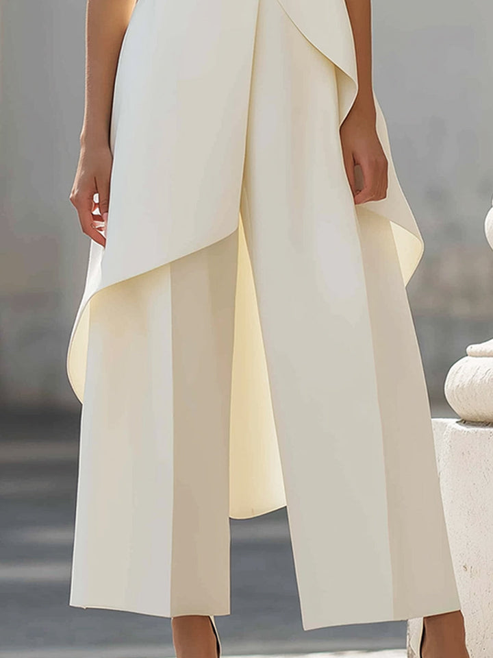 Conjunto de dos piezas para mujer, top asimétrico y pantalón ancho. Versátil para cena o fiesta elegante.