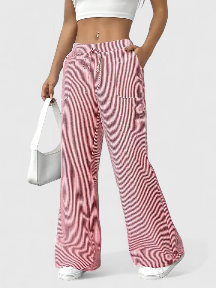 Pantalón rosa pastel de corte ancho, tejido ligero. Para un estilo casual y relajado.
