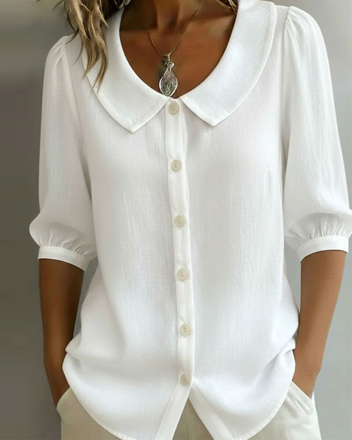 Camisa mujer de espalda con cuello Peter Pan. Manga fluida, estilo casual elegante para ropa de primavera.