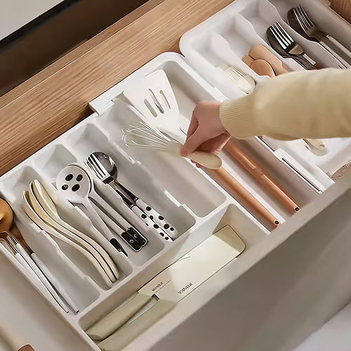 Organizador modular de cajones en negro, extensible y ajustable, ideal para cocina, oficina y hogar.