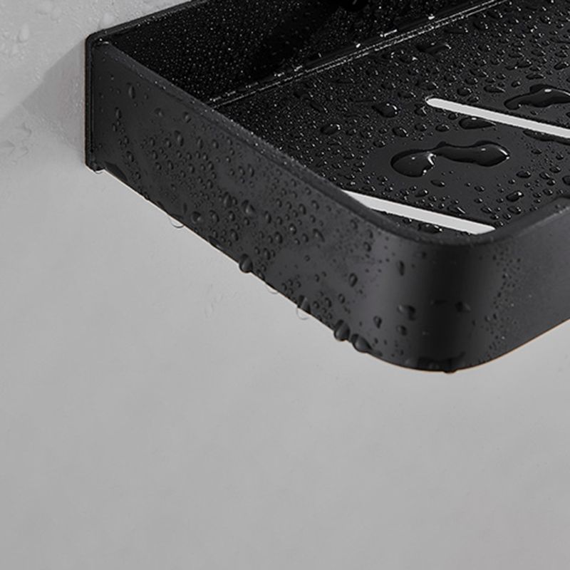 Estante de baño negro mate, perfecto para cosméticos y accesorios.
