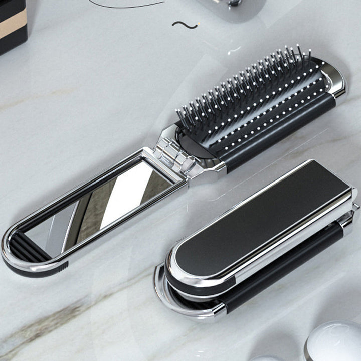 Espejo y cepillo de viaje plegable, ideal para cuidado personal y belleza portátil en cualquier lugar.