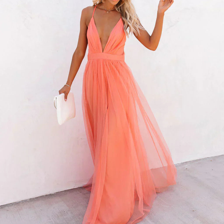 Vestido largo fluido rosa para mujer con espalda descubierta y escote en V, ideal para verano o fiesta.