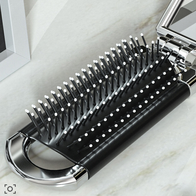 Pequeño espejo y cepillo de pelo plegable, ideal para llevar en cartera o neceser de viaje fácilmente.