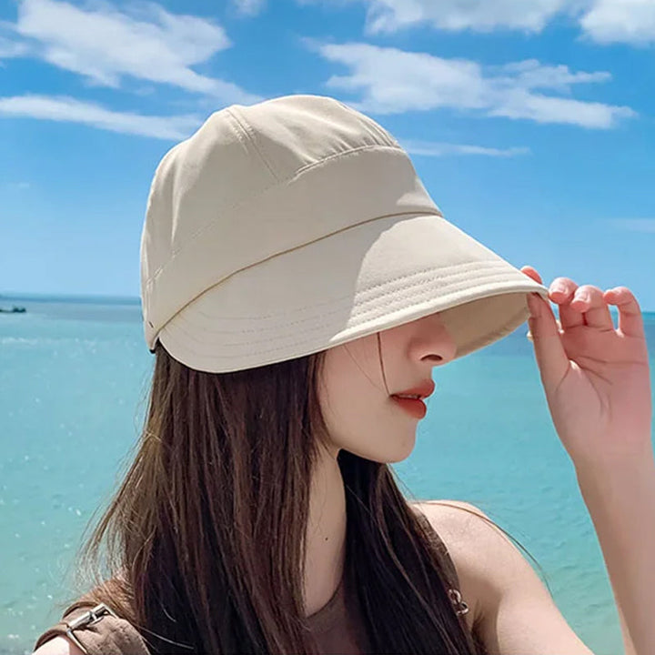 Sombrero de ala ancha UV para mujer, protege del sol en días sin maquillaje.