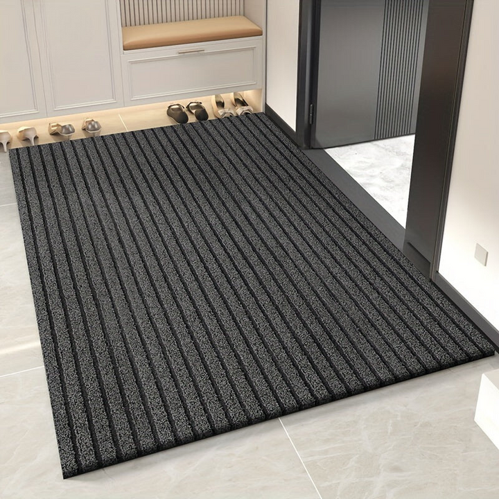 Alfombra de entrada duradera para exterior. Fibra resistente a la intemperie y alto tráfico.