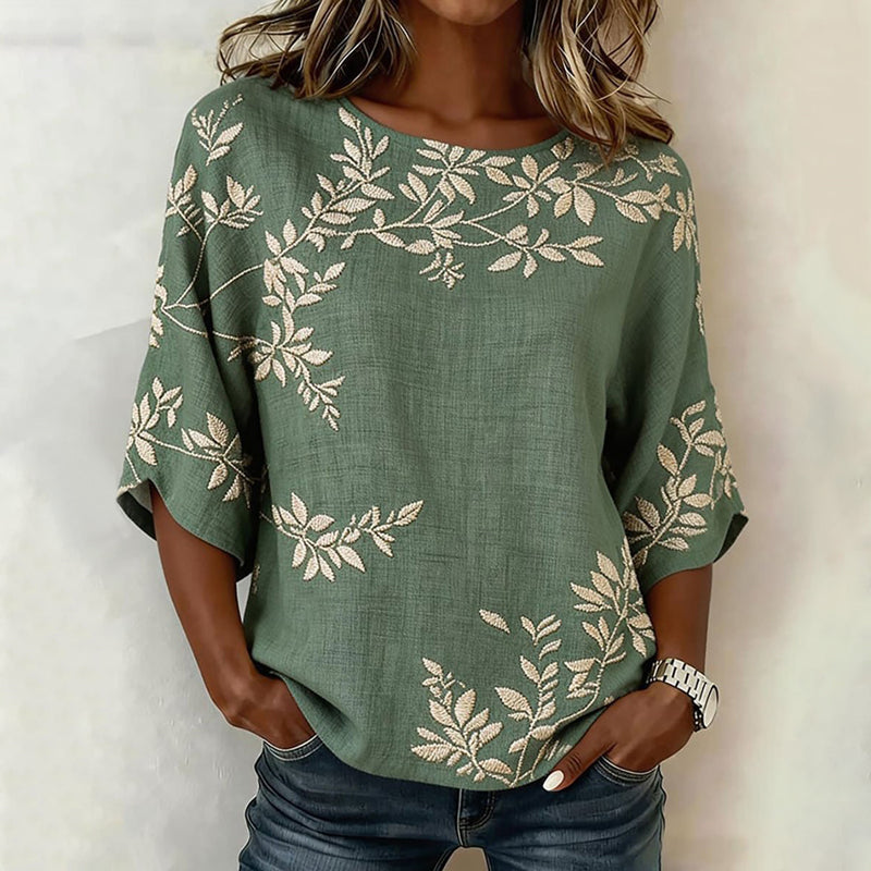 Blusa vintage de mujer verde con estampado de hojas, manga corta. Ideal para un look fresco y casual de verano.