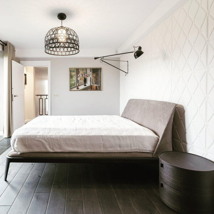 Aplique de pared industrial ajustable, ideal para iluminación de lectura en dormitorio blanco.