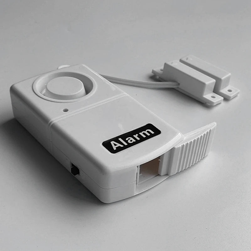 Alarma de seguridad portátil para puertas, compacta y sin cables. Ideal para protección del hogar y viajes.