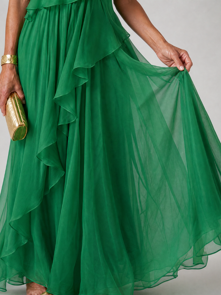 Vestido blanco puro maxi asimétrico con volantes delicados, perfecto para eventos de día o noche.