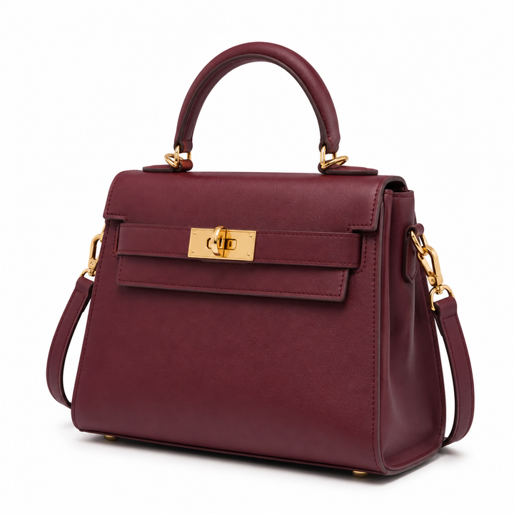 Bolso de mano burdeos elegante para mujer, confeccionado en cuero sintético, detalle de cierre metálico dorado.