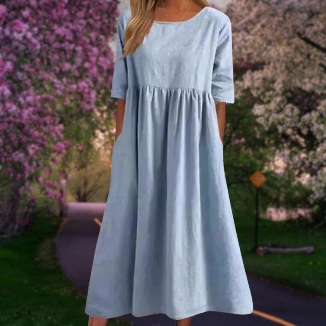 Vestido fluido midi de mujer, ideal para la comodidad veraniega, con caída elegante y ligera.