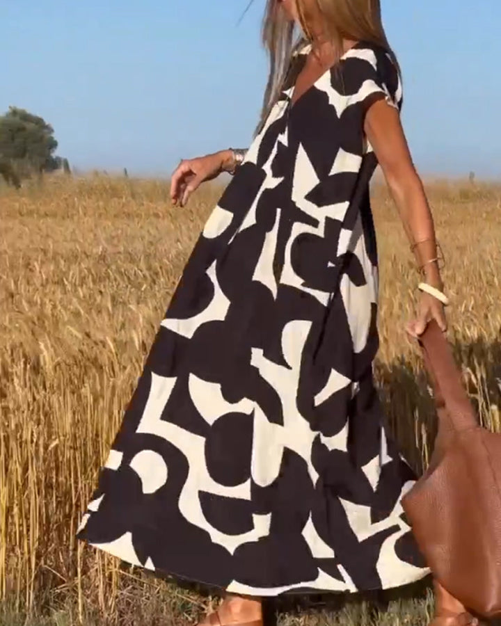 Vestido casual estampado para mujer, estilo fluido con escote V y manga corta cómoda.