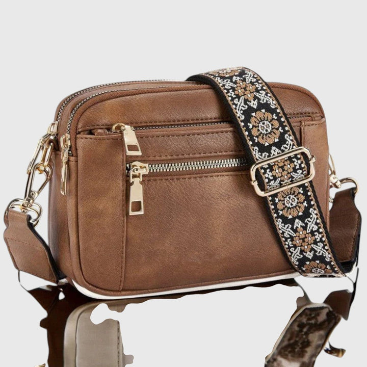 Bolso cruzado para mujer, compacto y versátil. Correa floral ajustable ideal para viaje o diario.