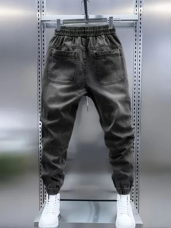 Modelo masculino vistiendo pantalón denim negro de corte amplio, comodidad y moda para uso casual.