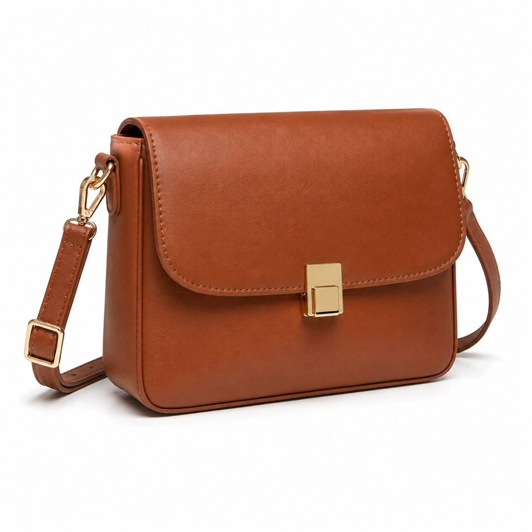 Bolso bandolera de mujer en cuero sintético marrón. Accesorio de moda chic para cualquier ocasión.