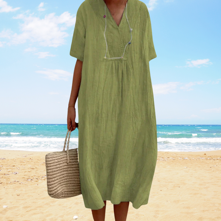 Mujer con vestido midi de verano fluido y escote en V profundo, cómodo y elegante para días calurosos.