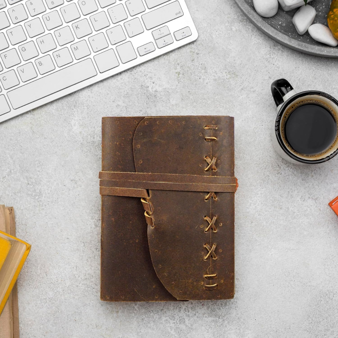 Cuaderno de cuero vintage con textura y bolígrafo, ideal para notas y un diario personal portátil.