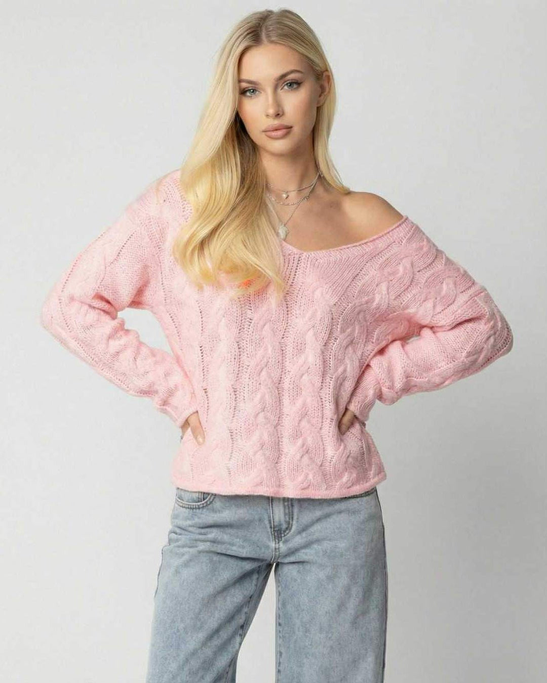 Suéter rosa de cuello V para mujer, ajuste relajado y moderno, ideal para un look casual de otoño o invierno.