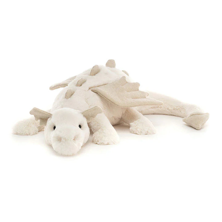 Dragón de peluche suave posado en una cama, esperando ser el compañero de abrazos ideal.