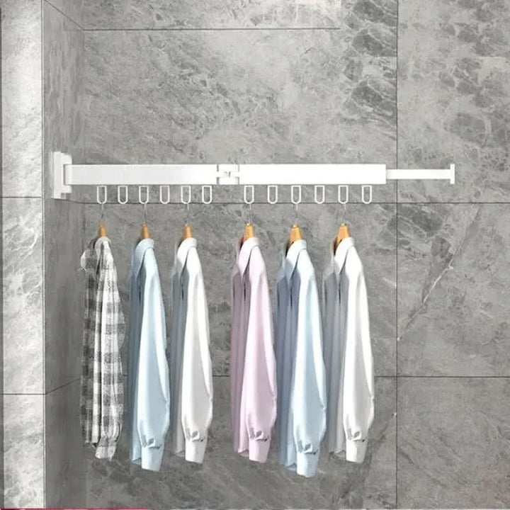 Organizador de ropa plegable de pared, tendedero moderno que maximiza el espacio en lavanderías pequeñas.