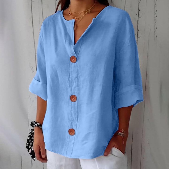 Blusa de mujer, diseño de cuello V, en algodón lino, transpirable. Ideal para el confort y la moda veraniega.