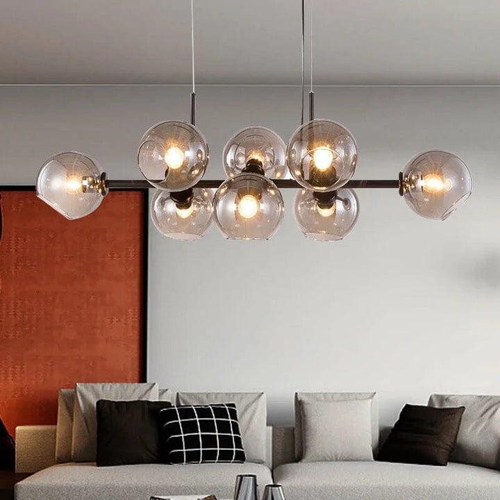 Lámpara moderna para comedor, burbujas LED, diseño negro y oro, ambiente acogedor.