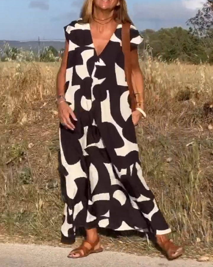 Vestido de mujer con estampado primaveral, diseño fluido, escote en V y manga corta.