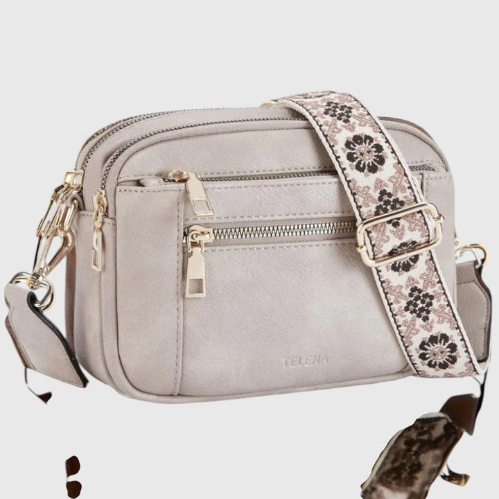 Bolso de hombro casual para mujer. Confortable y versátil, con correa floral ajustable para uso diario.