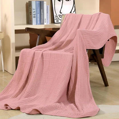Manta de gasa ultraligera y transpirable, perfecta para climas cálidos y como toque decorativo.