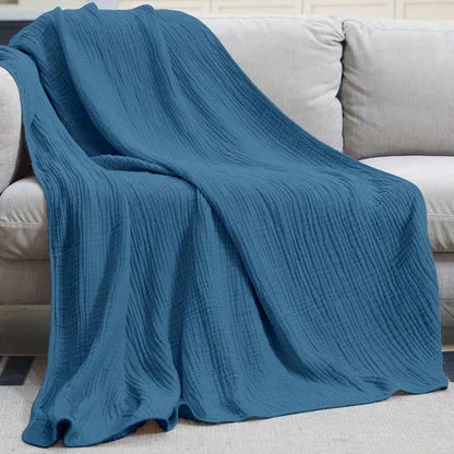 Manta ligera de algodón orgánico para cama o sofá, brindando confort natural y transpirable.