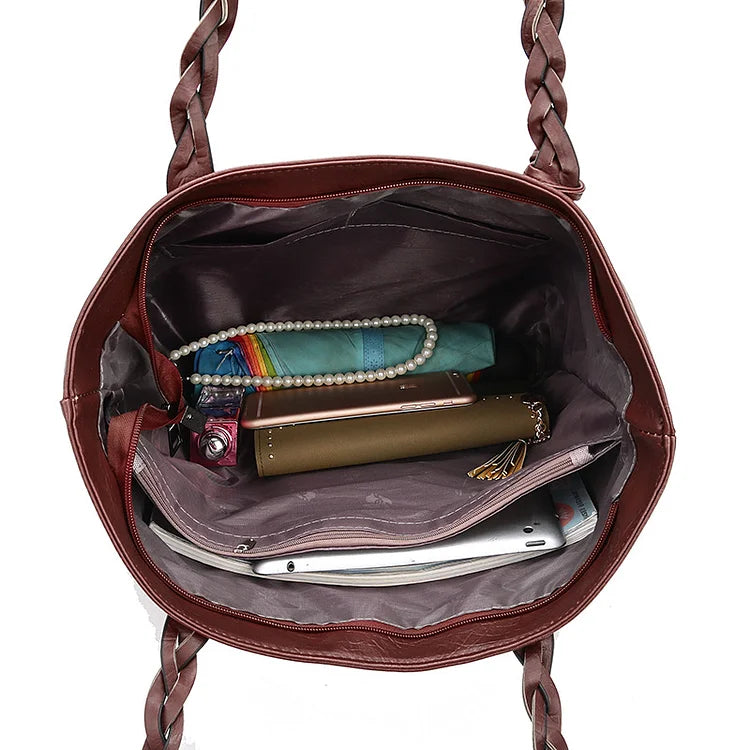 Cartera de lujo negra estructurada para mujer, con asa superior, perfecta para un estilo sofisticado y diario.