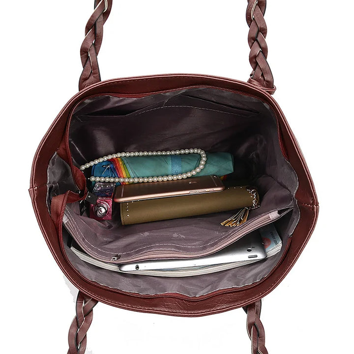 Cartera de lujo negra estructurada para mujer, con asa superior, perfecta para un estilo sofisticado y diario.