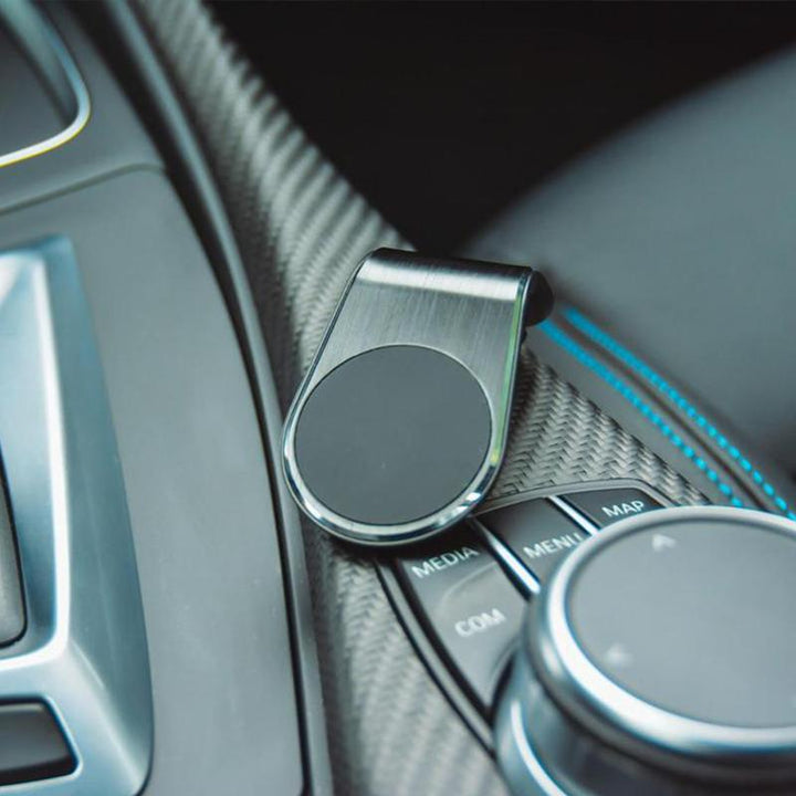 Soporte magnético para teléfonos, disponible en dorado y negro, para la rejilla del aire del coche. Uso manos libres.