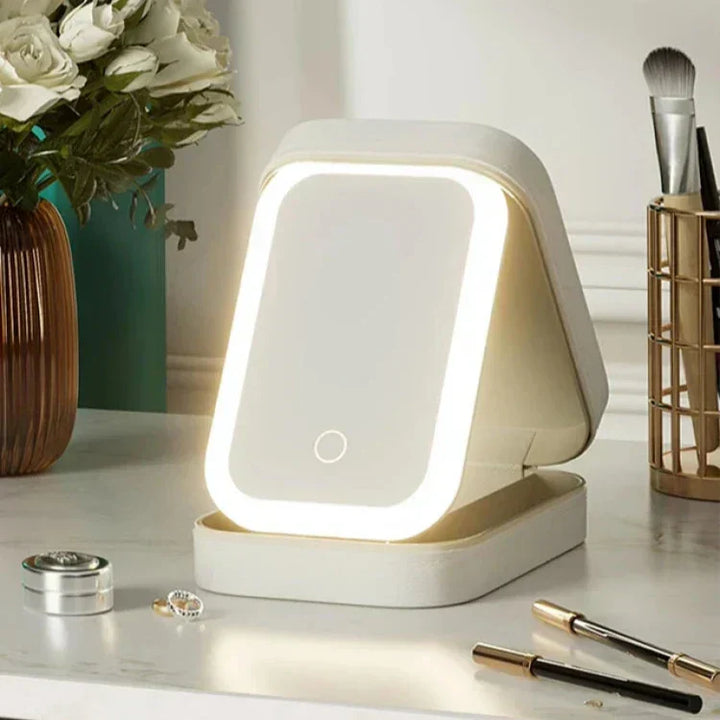 Neceser de maquillaje LED con carga USB. Espejo iluminado para cosméticos, ideal para uso móvil.