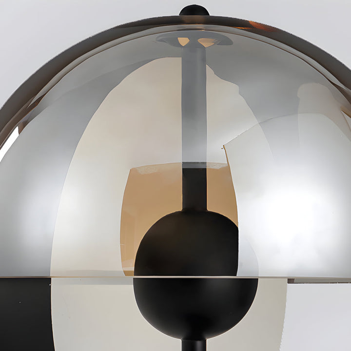 Lámpara de mesa esférica negra con base de metal y pantalla ahumada de cristal. Estilo y luz ambiental perfecta.