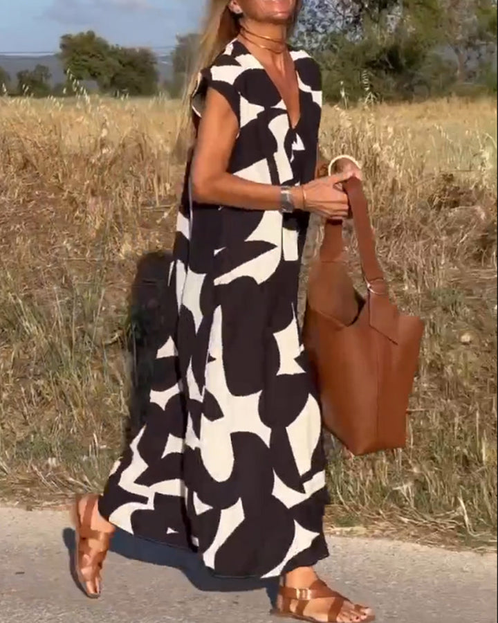 Vestido elegante fluido con estampado y escote V profundo, ideal para eventos de mujer.