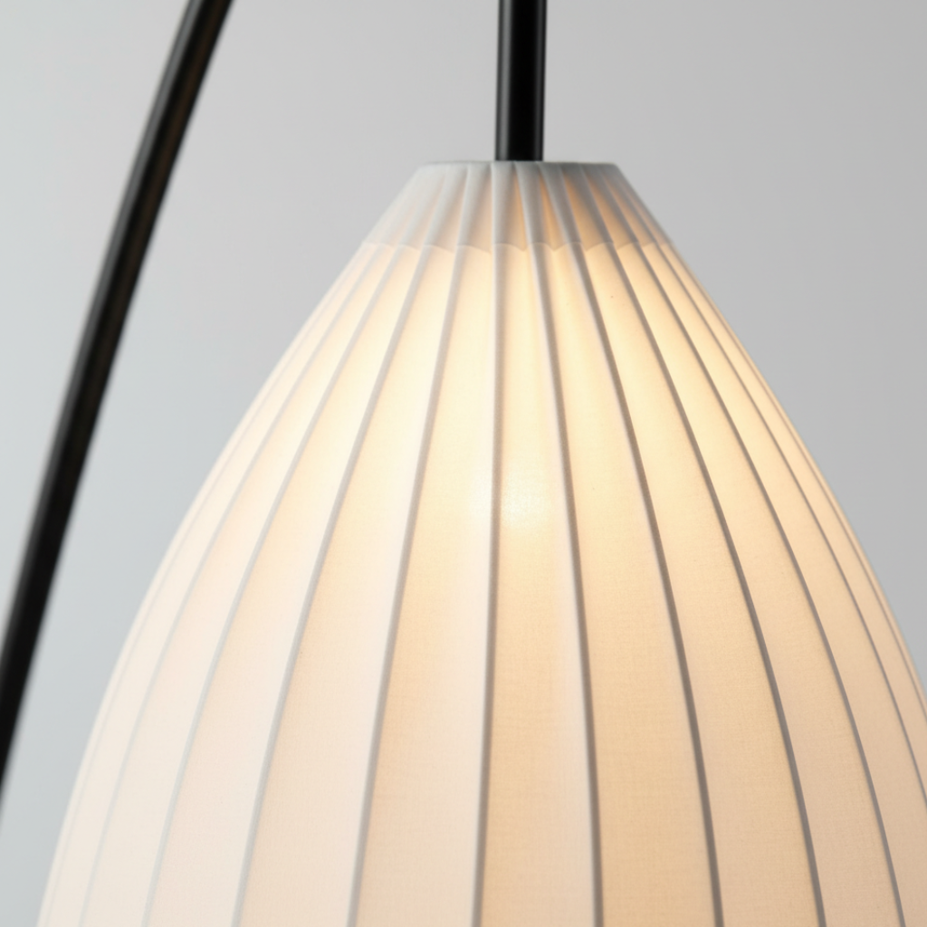 Moderna lámpara de pie con trípode. Pantalla plisada para una iluminación hogareña cálida.