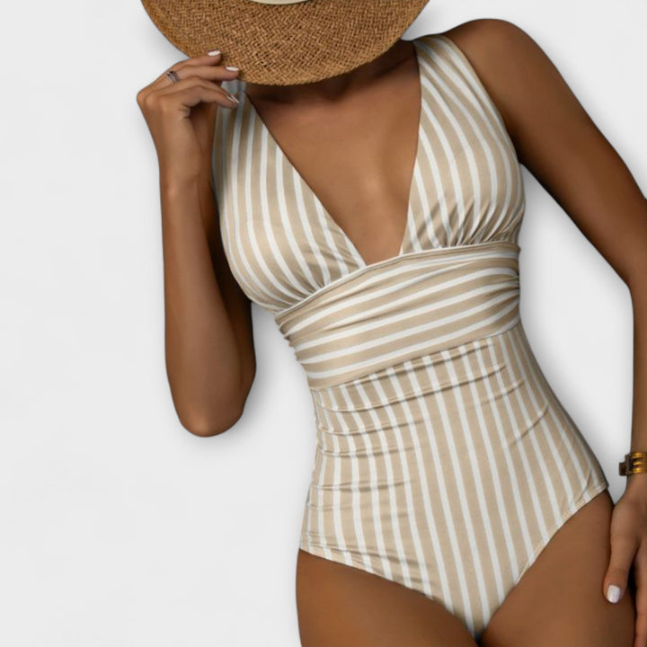 Bañador de mujer con rayas elegantes y escote en V pronunciado, ideal para lucir sofisticada en la piscina.