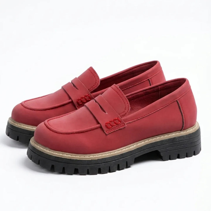 Calzado femenino de piel, mocasines slip-on con suela gruesa, estilo casual moderno.