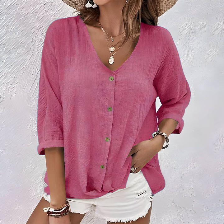 Elegante blusa de mujer con cuello V y manga larga abotonada. Versátil para outfits casuales o formales.