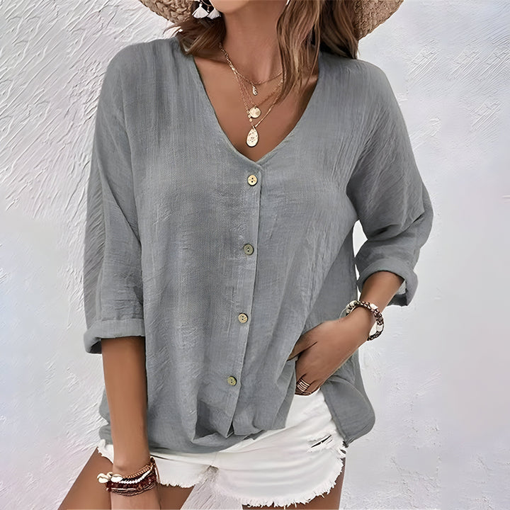 Cómoda blusa mujer cuello V, manga larga. Diseño relajado con botones, perfecta para tops de primavera.