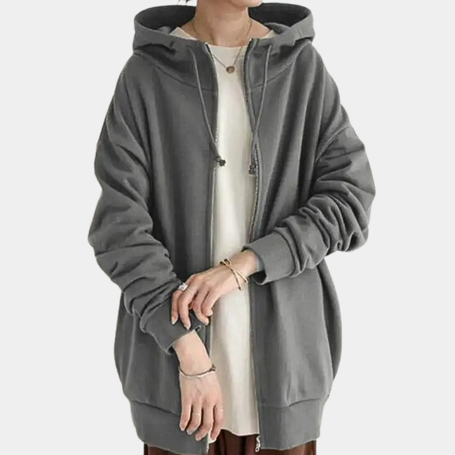 Sudadera de mujer con capucha y cremallera, perfecta para outfit diario. Prenda cómoda y versátil de moda casual.