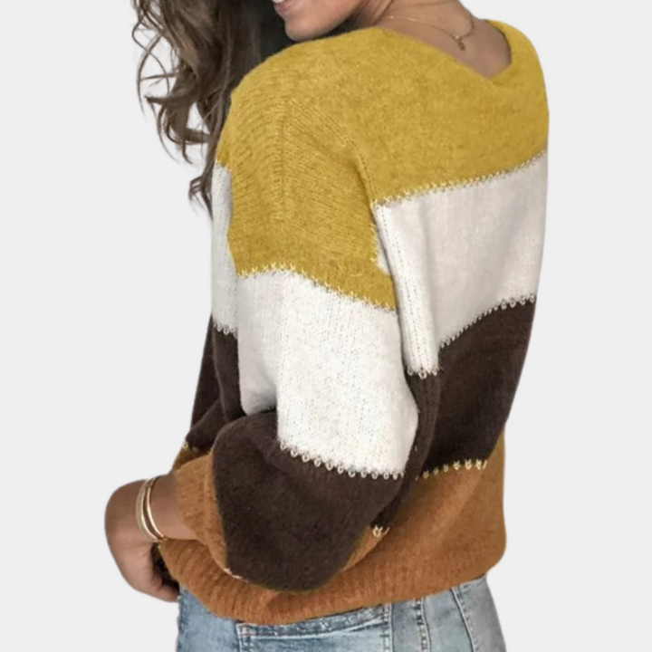 Jersey de mujer con vibrantes bloques de color, estilo moderno y holgado. Perfecto para moda de invierno.