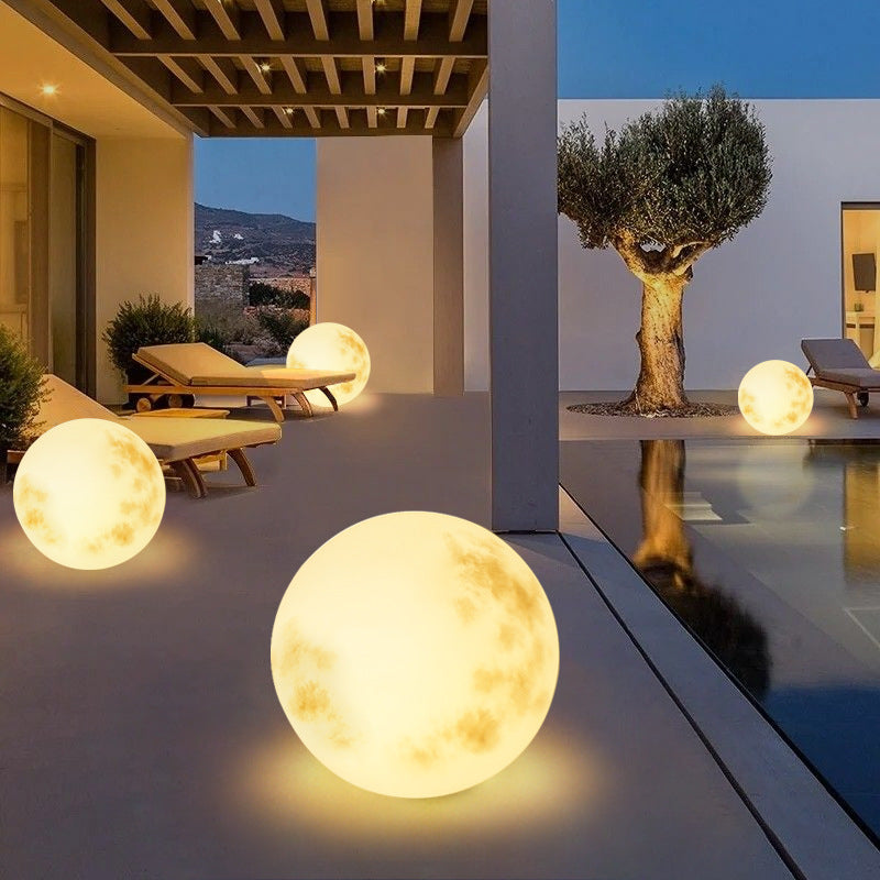Lámpara solar LED de jardín con diseño de luna para iluminación exterior, eficiente y con ambiente cálido en el jardín.