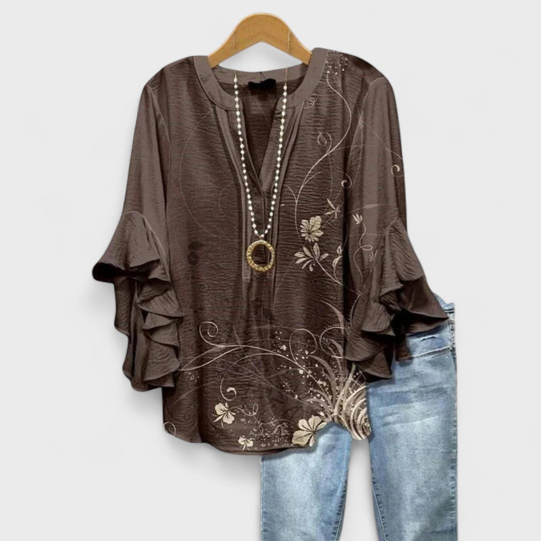 Estilosa blusa Celia de mujer con manga larga, volantes y delicado estampado floral.