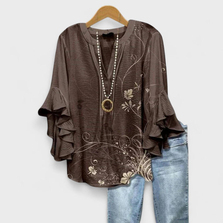 Estilosa blusa Celia de mujer con manga larga, volantes y delicado estampado floral.