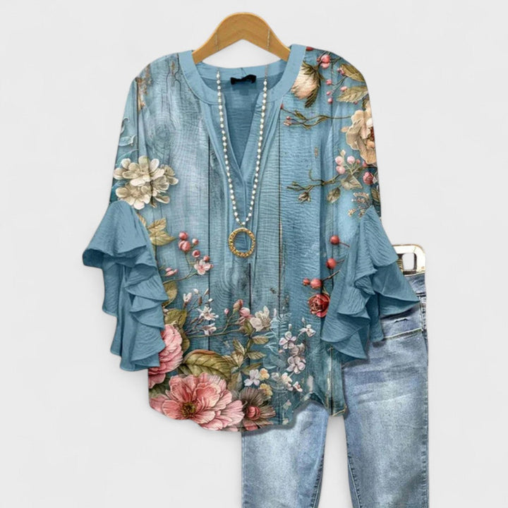 Top de mujer Celia con volantes, estampado floral, manga larga, estilo primaveral.