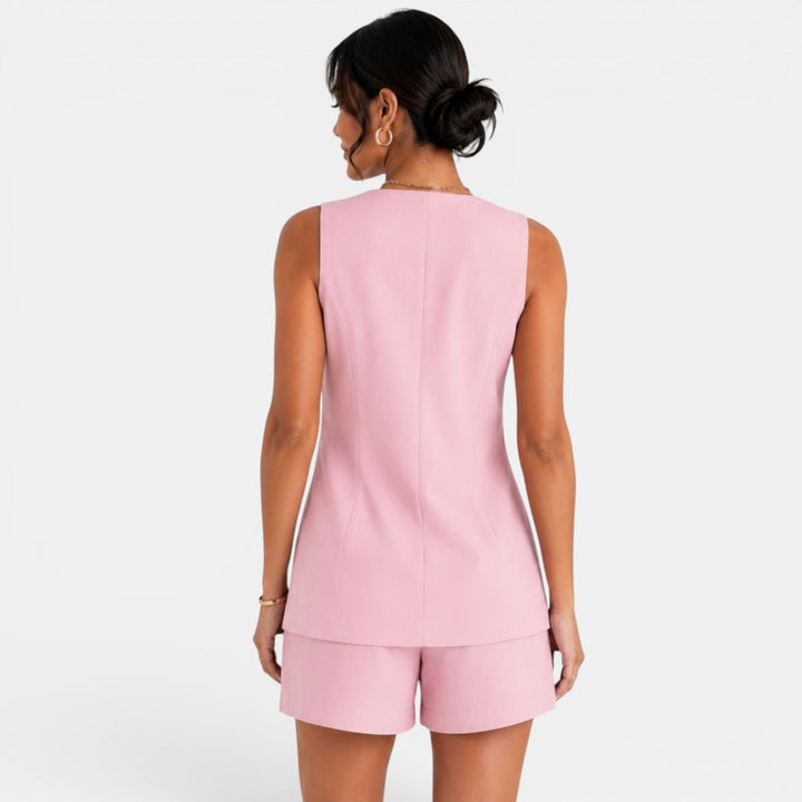 Conjunto de chaleco y pantalón corto de mujer tendido, mostrando su diseño elegante y casual. Moda versátil.